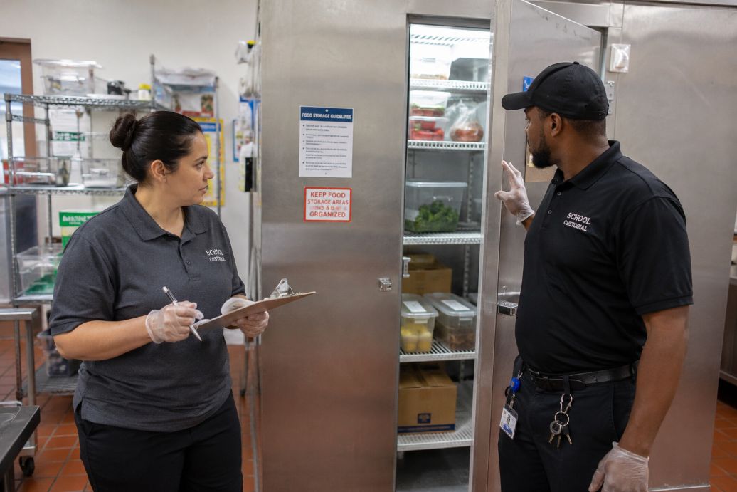 School custodial staff inspecting cafeteria sanitation